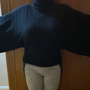 100% Cashmere Black turtleneck, full bell sleeves cropped fitted waist.size med
